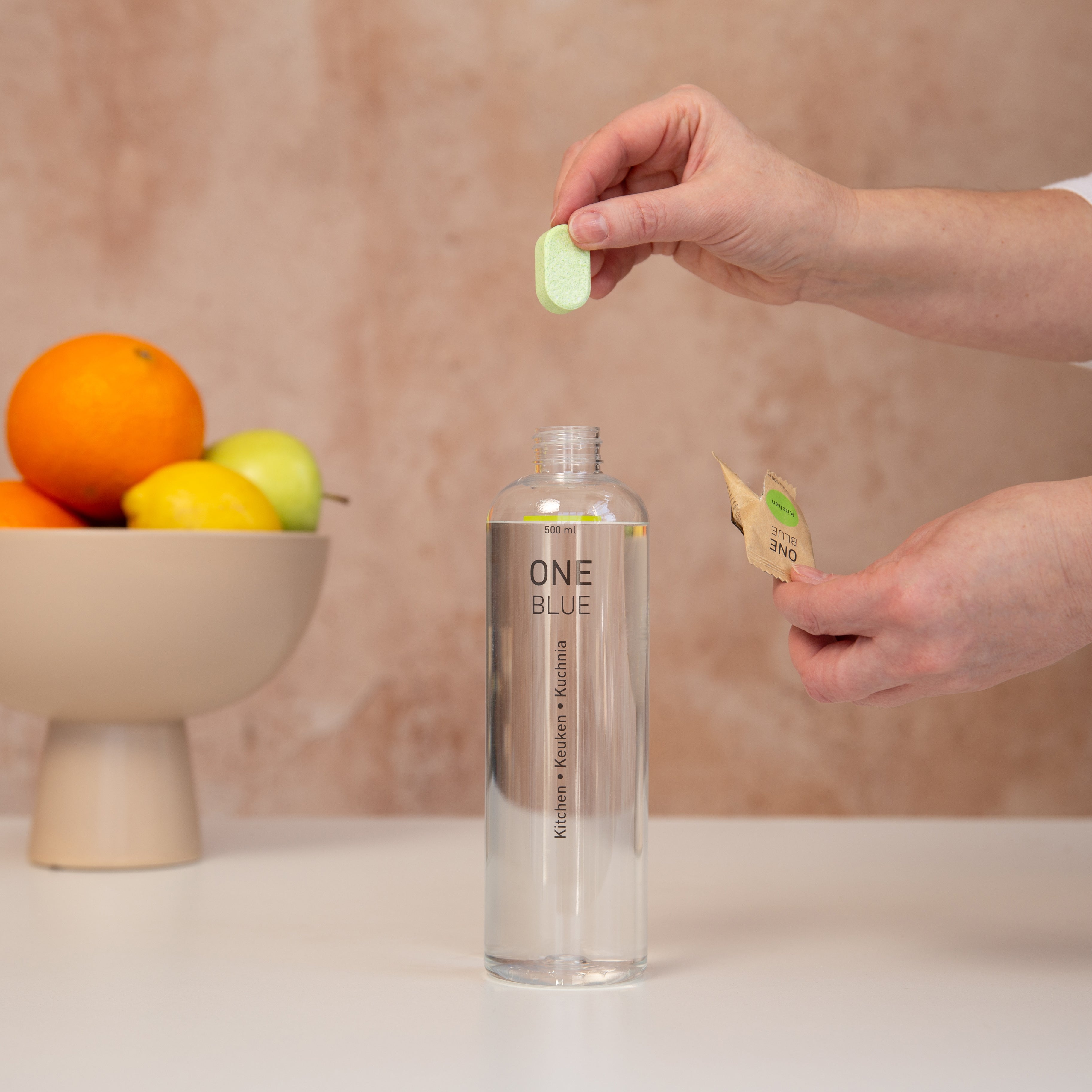 Adding a One Blue tablet to a reusable bottle with water